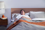 Man sleeping cooler to improve his deep sleep and prevent risk of dementia, too.