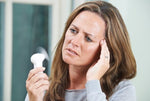 Woman experiencing hot flashes and menopause symptoms, and in need of cooler sleep
